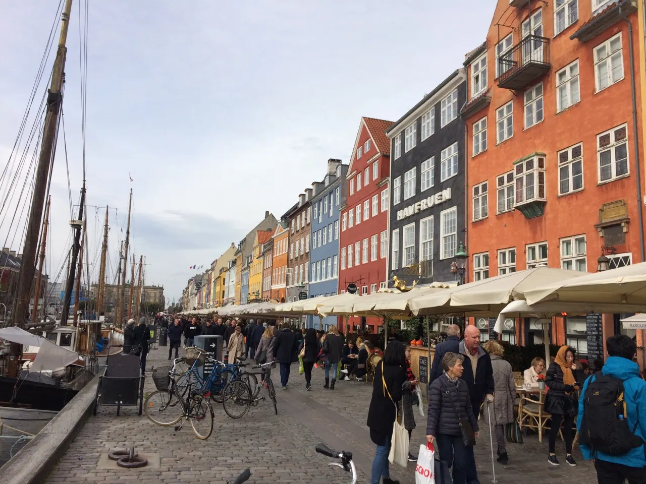 Terrasjes en oude zeilboten langs de kade van Nyhavn