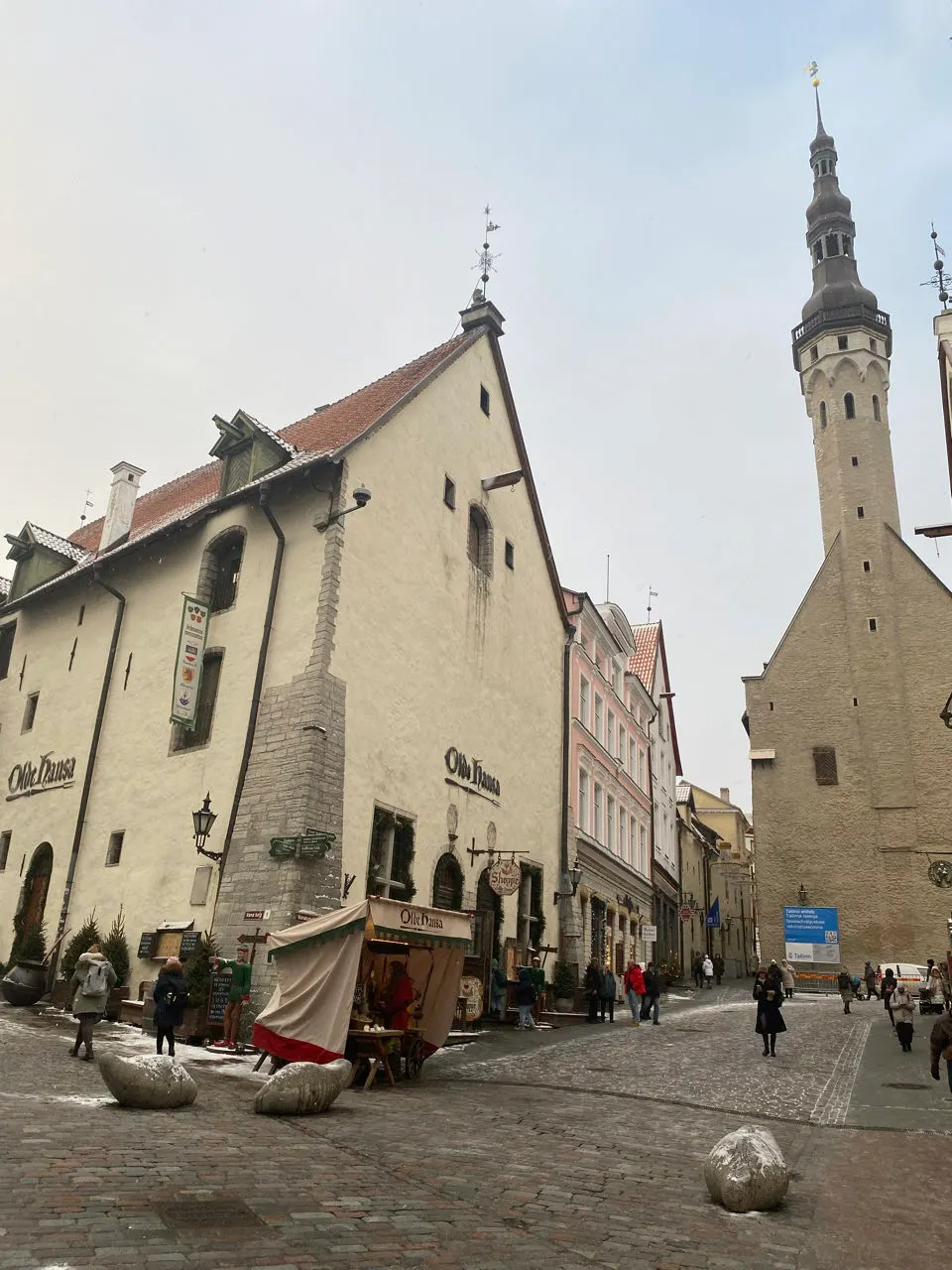 Straat in de oude binnenstad van Tallinn met een kerktoren op de achtergrond